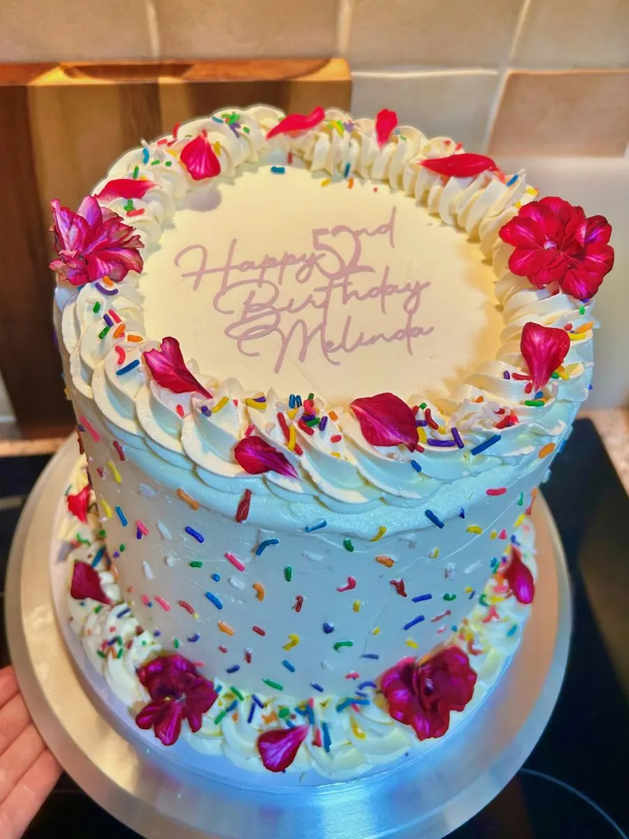 52nd birthday cake with sprinkles and pink flowers